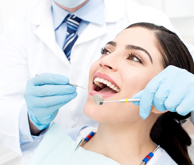 Female getting her teeth examined