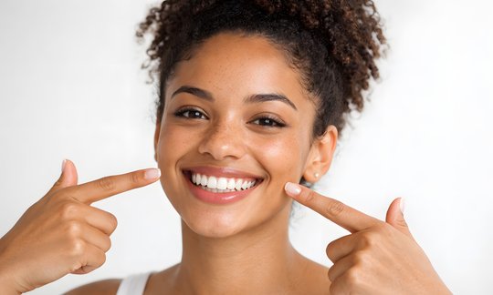 Adult patient smiling with clear aligner tray for orthodontic treatment